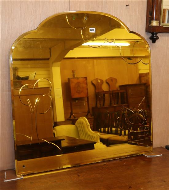 A 1950s frameless amber glass mirror 76cm